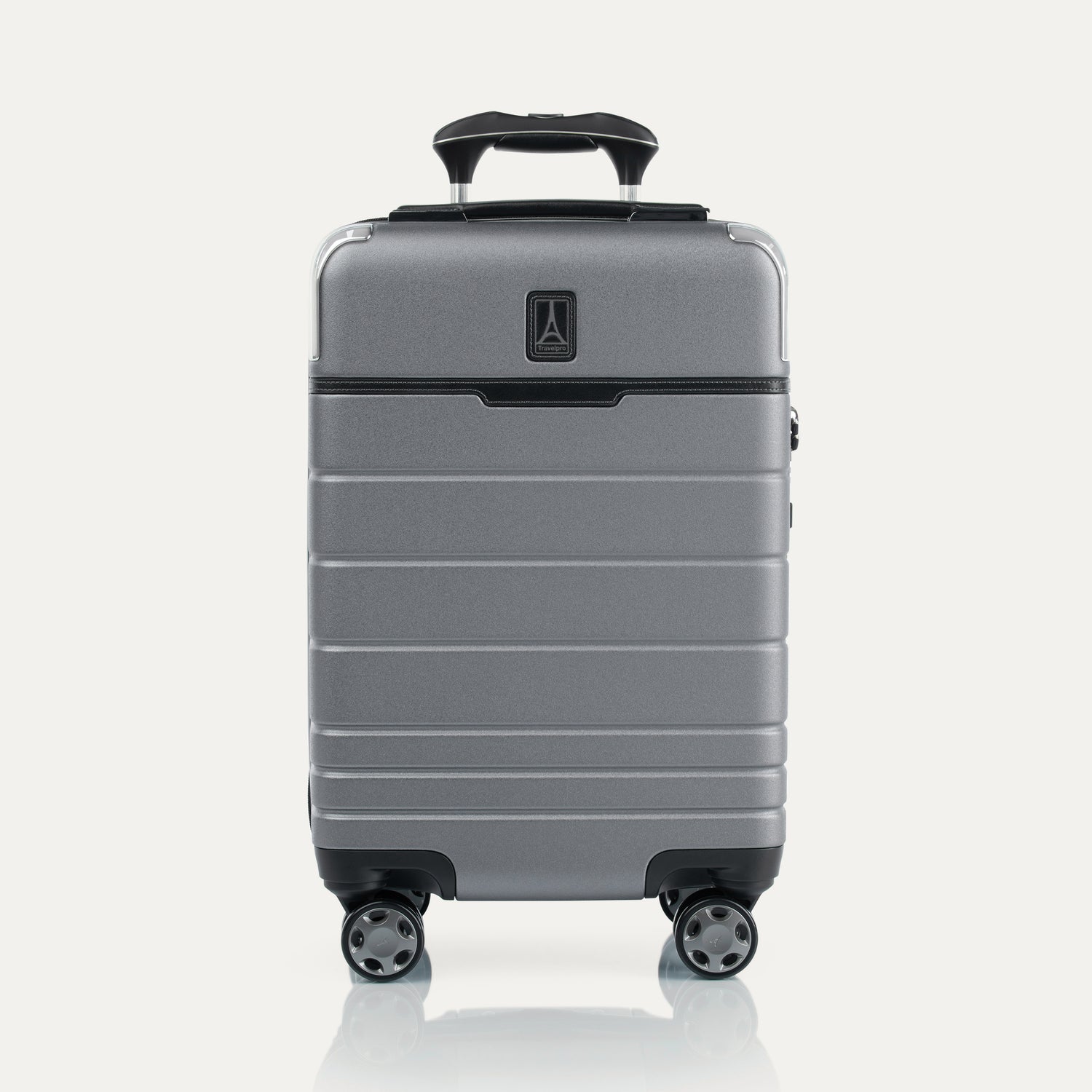Front view of T+L Compact Carry-On Spinner in Whistler Grey, featuring a smooth telescoping handle and grooved shell design.
