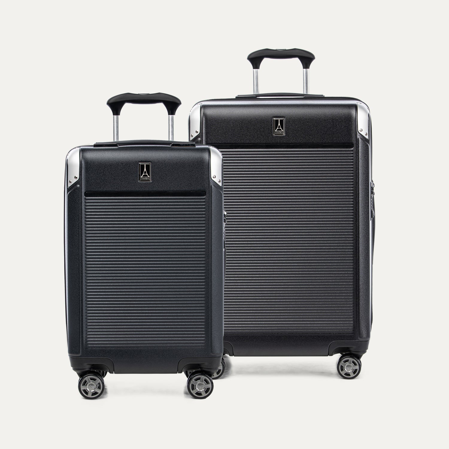 Two black suitcases with extended handles on a white background