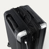 Black suitcase with power bank and USB cable on a white background