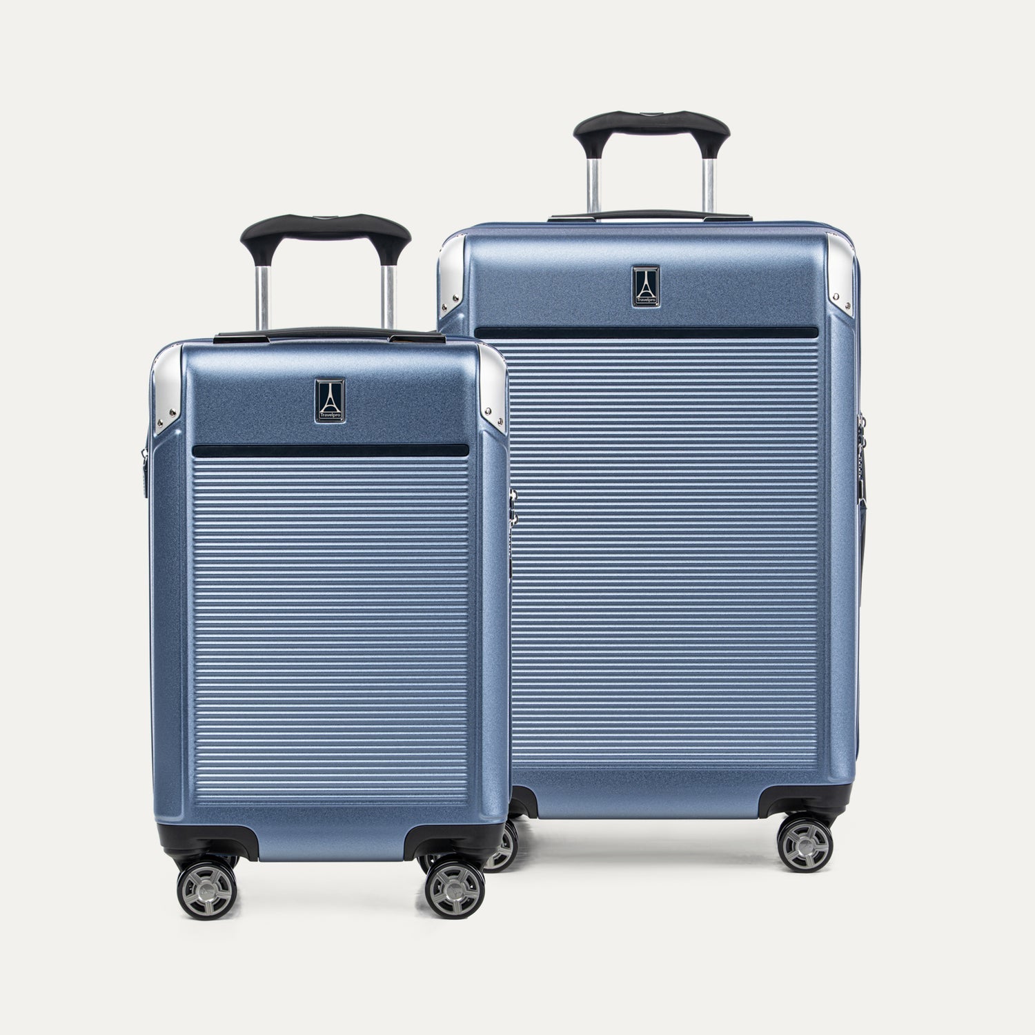Two blue suitcases with black handles on a white background
