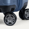 Close-up of blue suitcase wheels on a white background