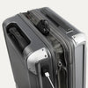 Close-up of a gray suitcase suitcase with USB cable outlet on a white background.