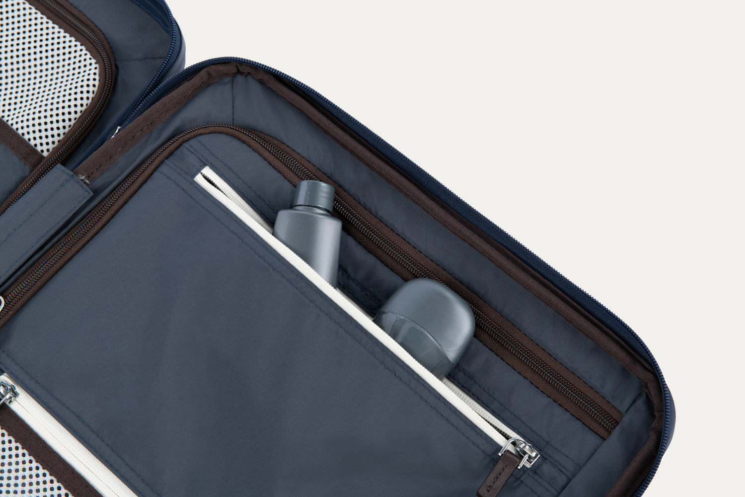 Close-up of a open suitcase interior with toiletries inside.