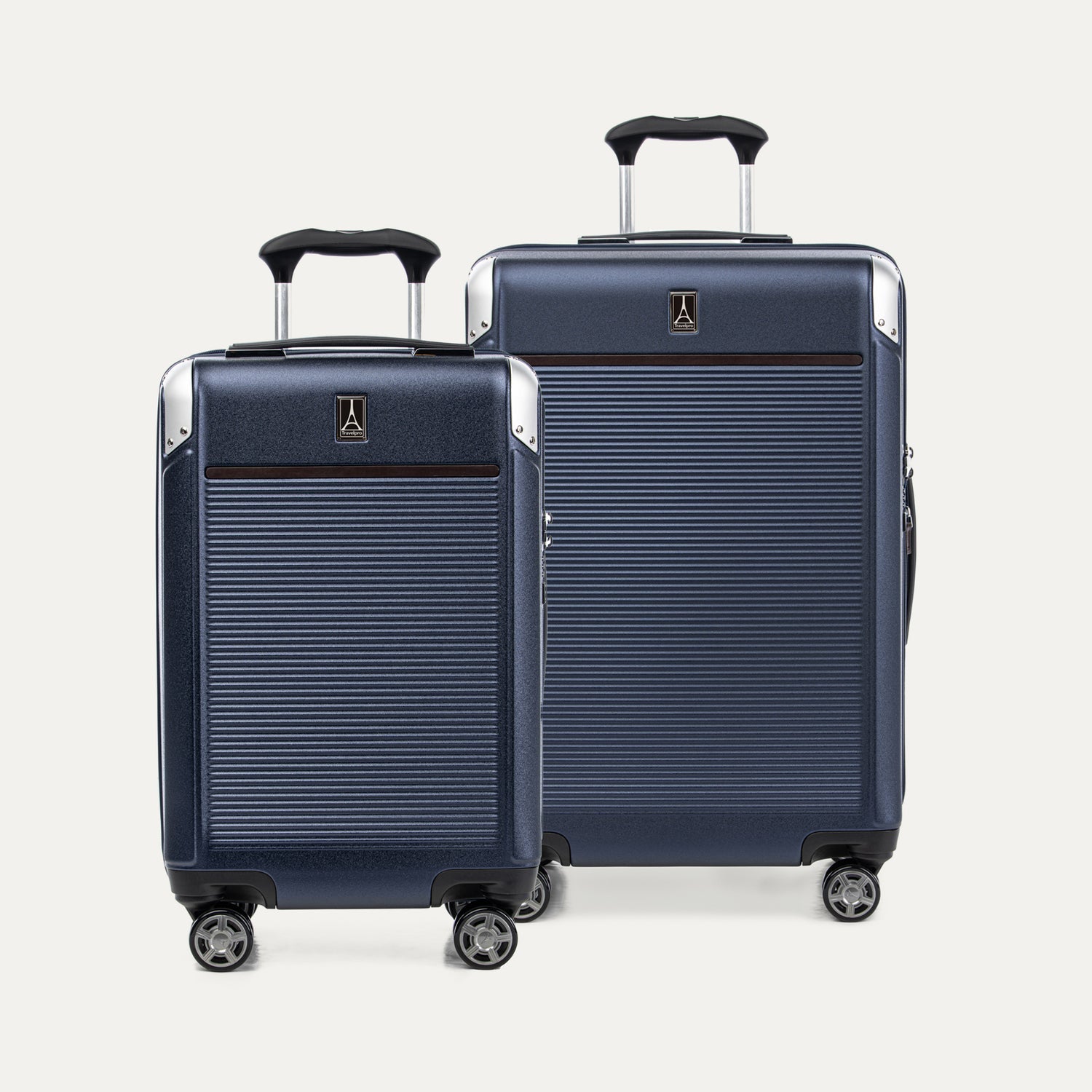 Two navy blue suitcases with black handles on a white background