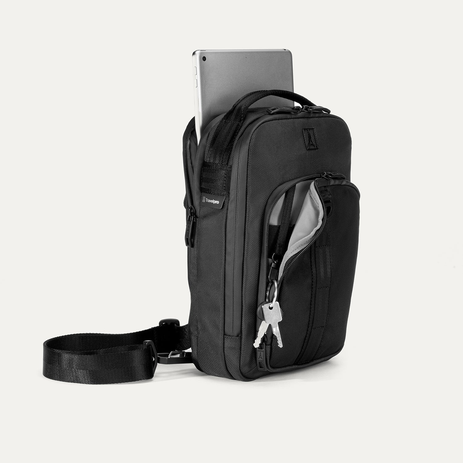 Front-right view of the Travelpro Altitude Crossbody 6L in Black, featuring a tablet compartment and key leash.
