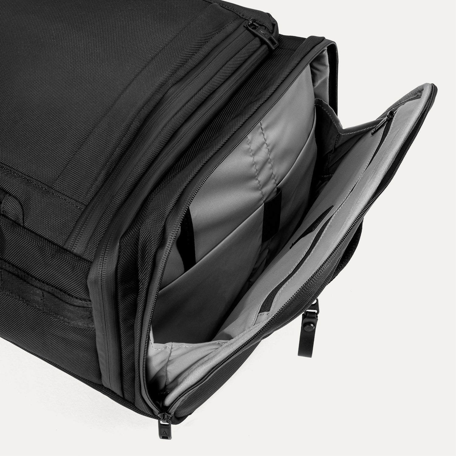 Open side compartment of the Travelpro Altitude Convertible Duffel/Backpack in Jet Black, revealing interior storage for accessories or gear.
