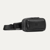 Travelpro Altitude Sling 2L in Jet Black, showing front zip pocket and adjustable strap with Travelpro tag.

