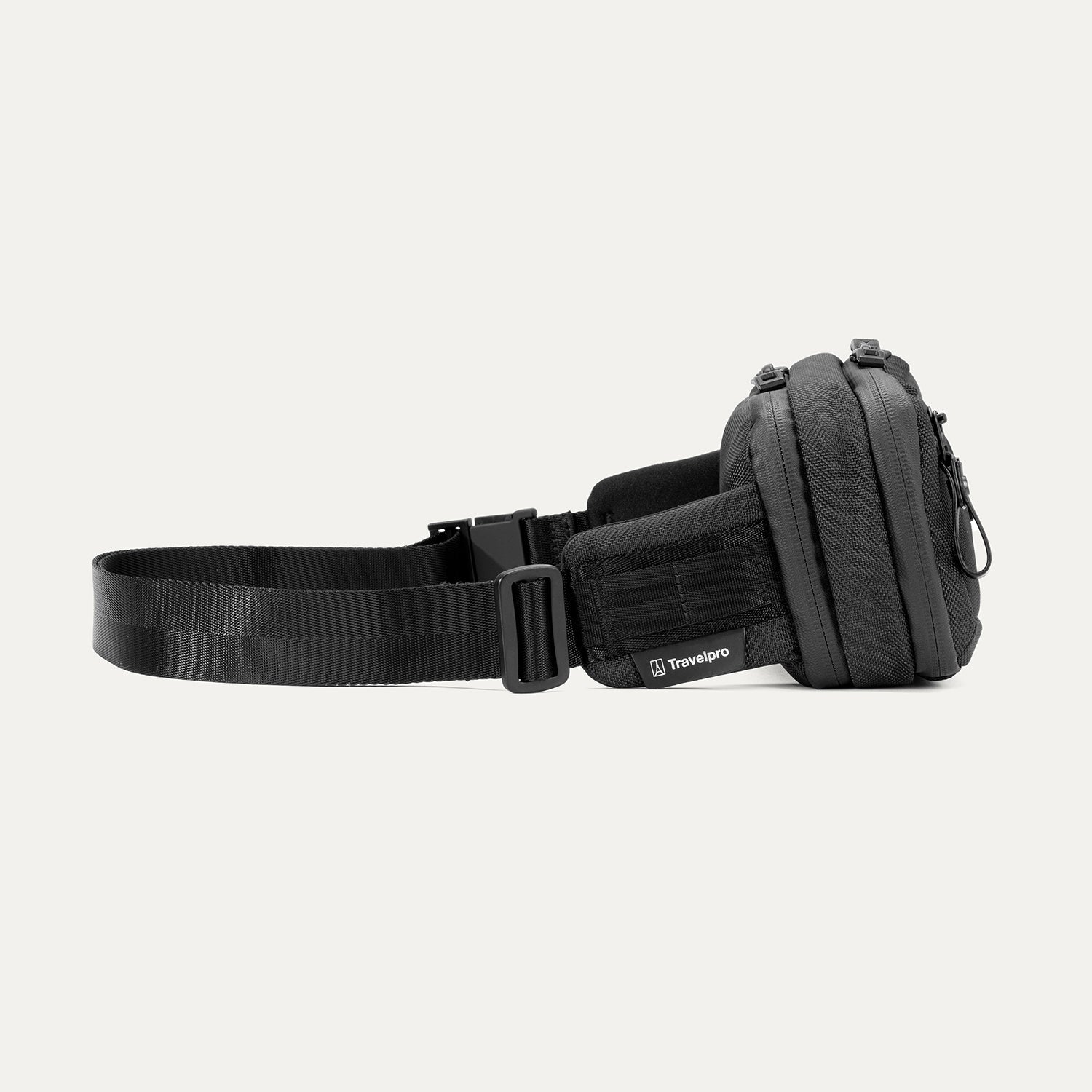 Side view of the Travelpro Altitude Sling 2L in Jet Black, showing Travelpro logo tab and adjustable buckle strap.

