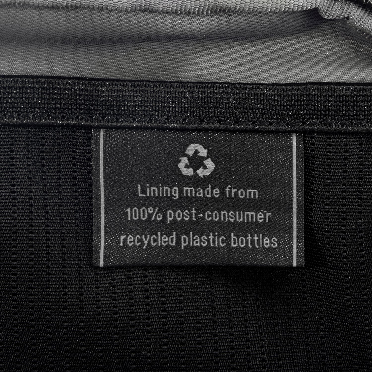 Close-up of interior tag showing that the lining is made from 100% post-consumer recycled plastic bottles.
