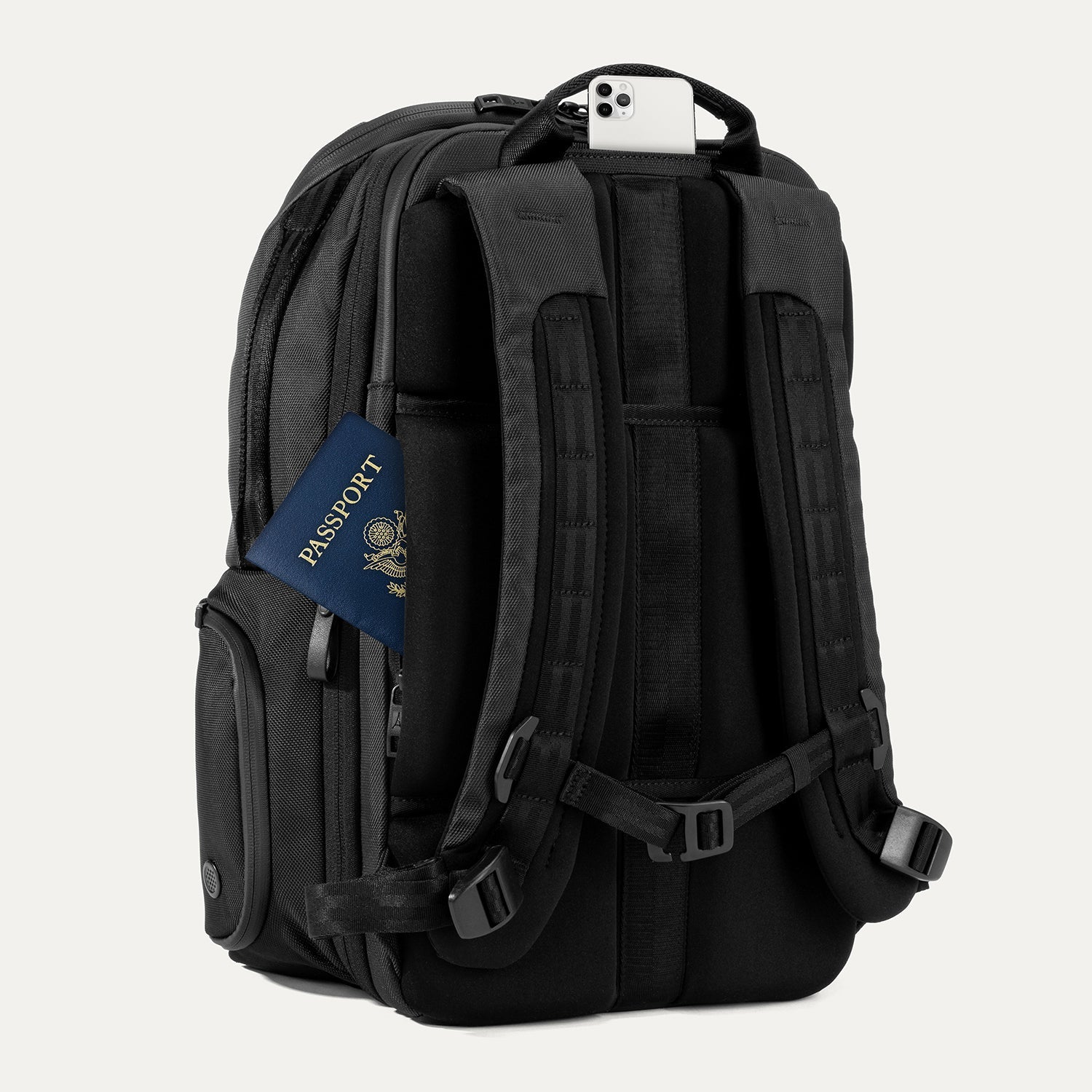 Rear view of Travelpro Altitude All-Purpose Laptop Backpack in Jet Black, featuring padded straps and QuickSlip Pocket with phone.
