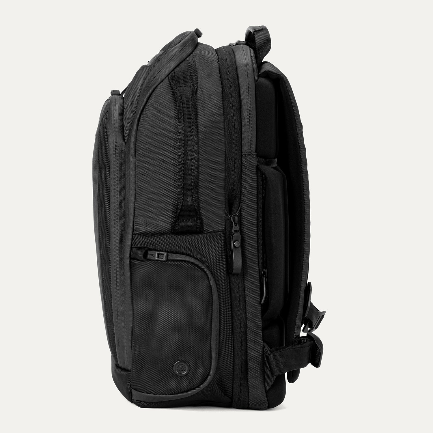 Side view of Travelpro Altitude All-Purpose Laptop Backpack in Jet Black, featuring zippered compartments and external gear pocket.
