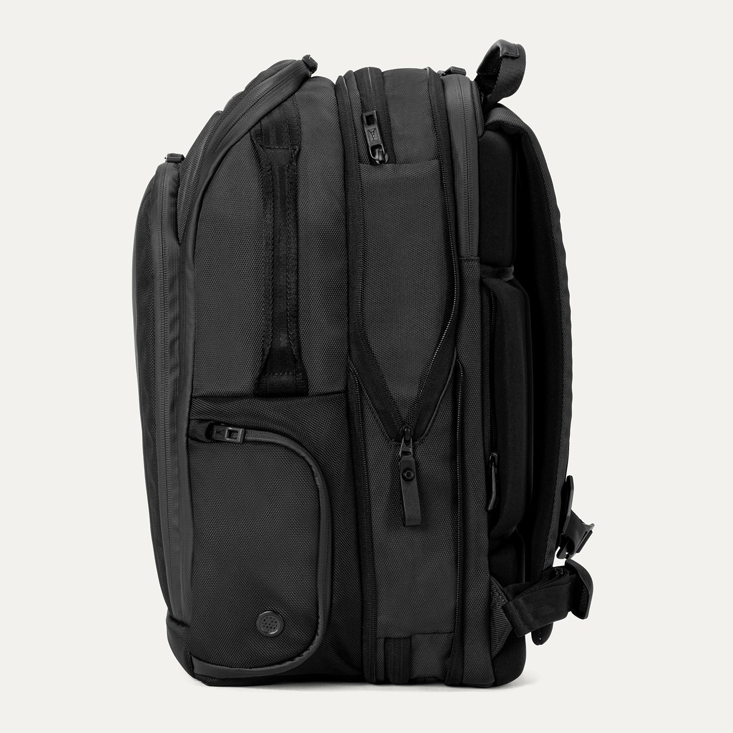 Expanded side view of Travelpro Altitude All-Purpose Laptop Backpack in Jet Black, showing zippered compartments and external gear pocket.
