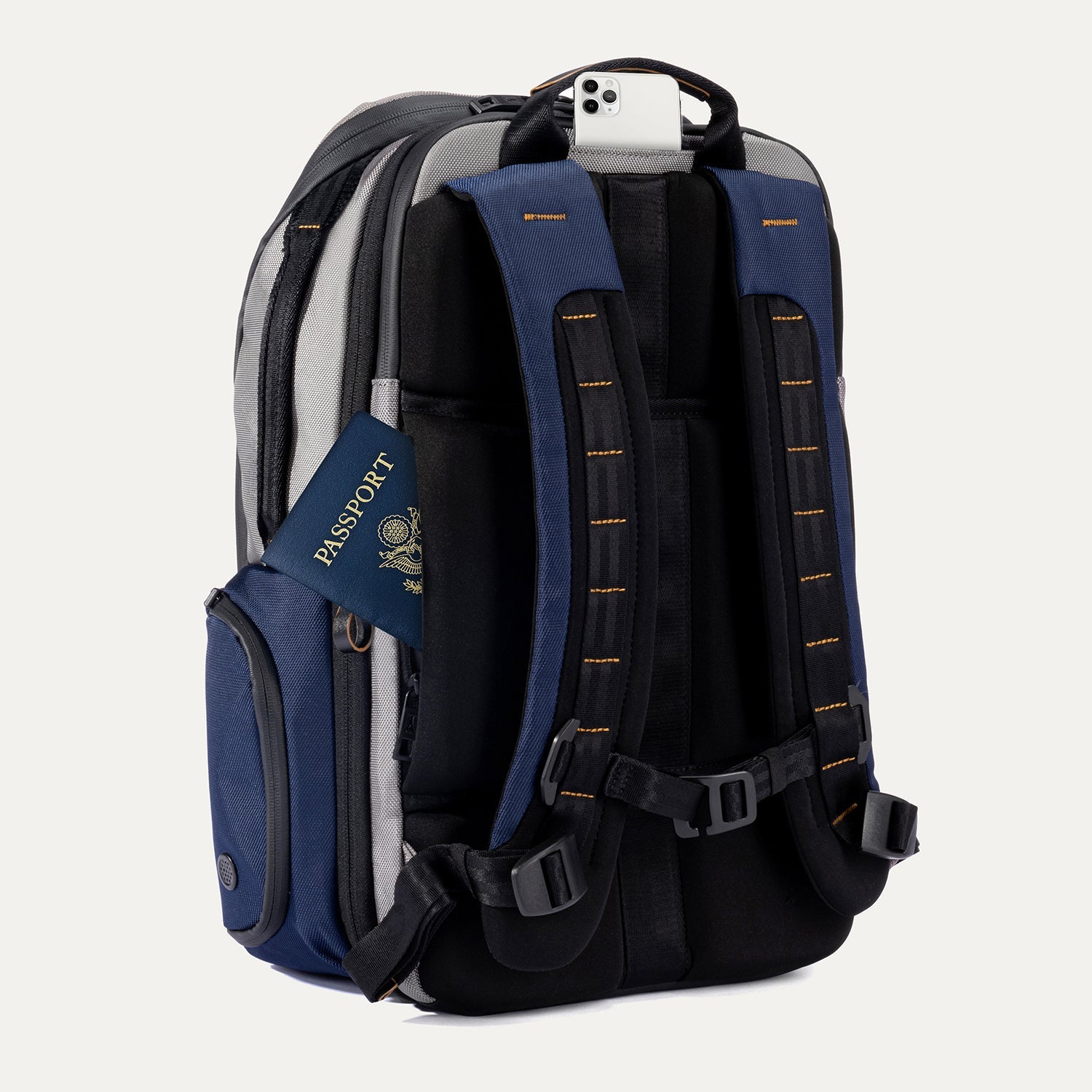 Rear angled view of the Travelpro Altitude All-Purpose Backpack in Stellar Navy/Grey, showing padded straps and back pocket access.

