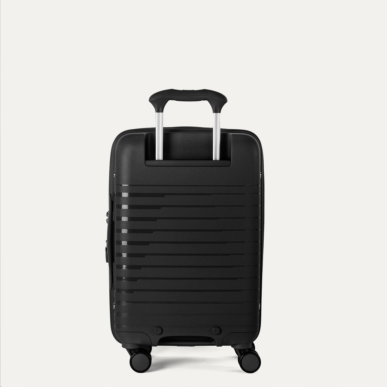 Rear view of the Optima Expandable Compact Carry-on Spinner in Black, showcasing the durable polypropylene shell, the extended telescoping PowerScope handle, and smooth-rolling spinner wheels.