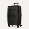 Three-quarter angled view of the Optima Expandable Medium Check-in Spinner in Black, showcasing the sleek, ribbed hardside shell, Travelpro branding, and smooth-rolling spinner wheels.
