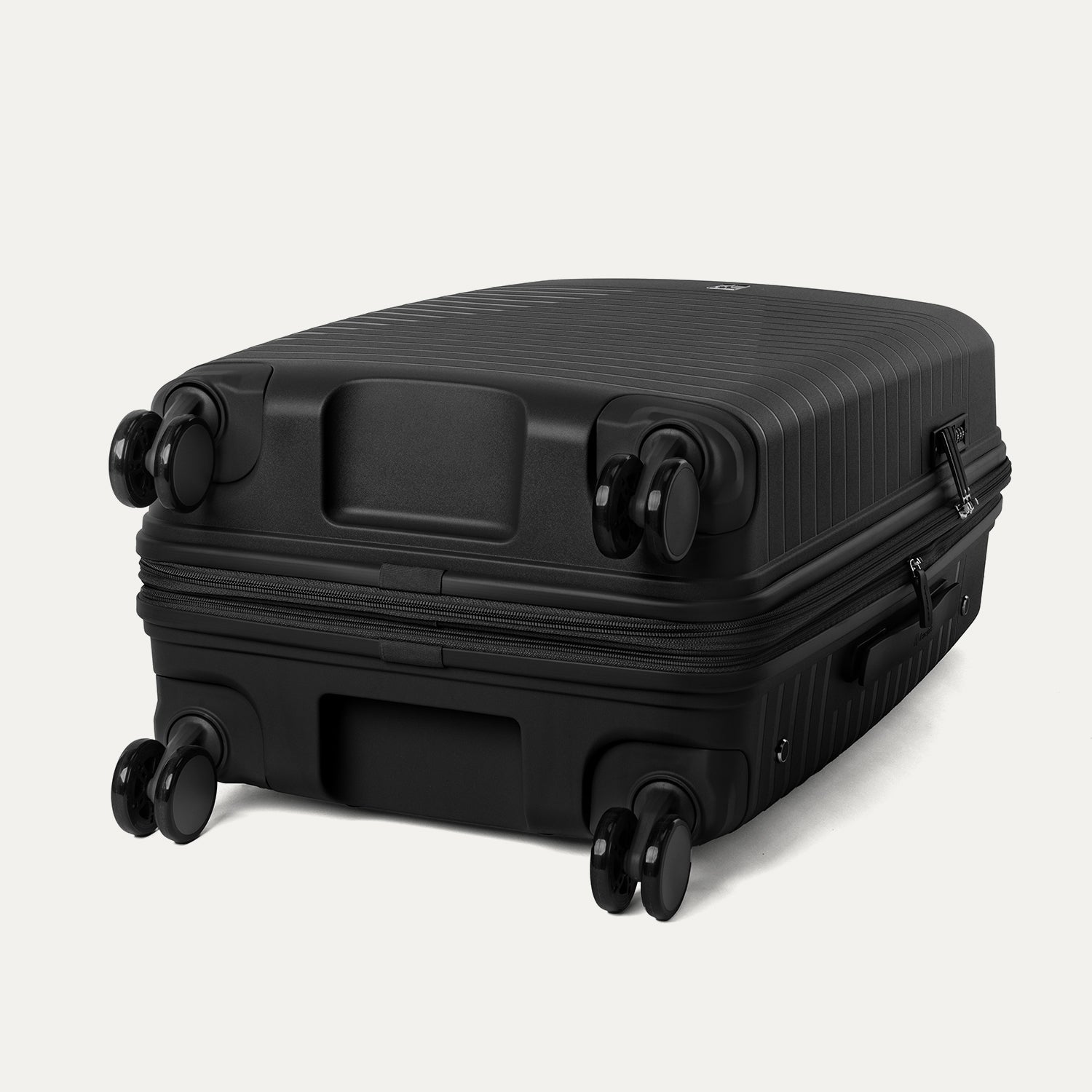 Underside view of the Optima Expandable Medium Check-in Spinner in Black, showcasing the durable base and self-aligning PrecisionGlide spinner wheels designed for smooth, effortless mobility.