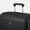 Close-up detail view of the top of the Optima Expandable Large Check-in Spinner in Black, highlighting the extended PowerScope handle, top carry handle, and Travelpro branding on the hardside shell.