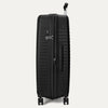 Side profile view of the Optima Expandable Large Check-in Spinner in Black, highlighting the integrated side carry handle, the TSA-compliant lock, and the suitcase's sleek, durable side profile.